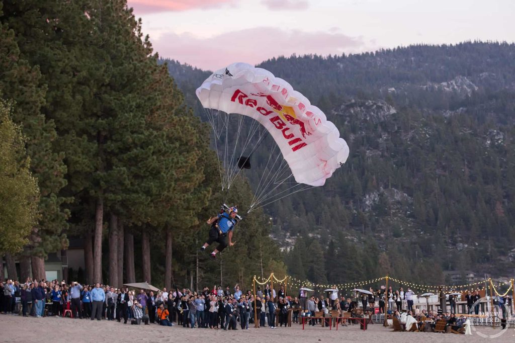 Red bull parachute skydiver on a beach at Lake Tahoe, California. Lake Tahoe corporate photographer and commercial photographer Drew Bird.