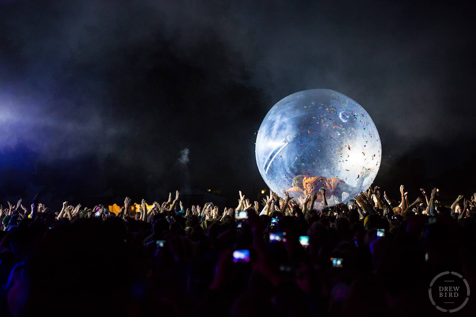 Person inside a clear inflatable ball being supported by a crowd at an event. Corporate event photography by San Francisco photographer Drew Bird.
