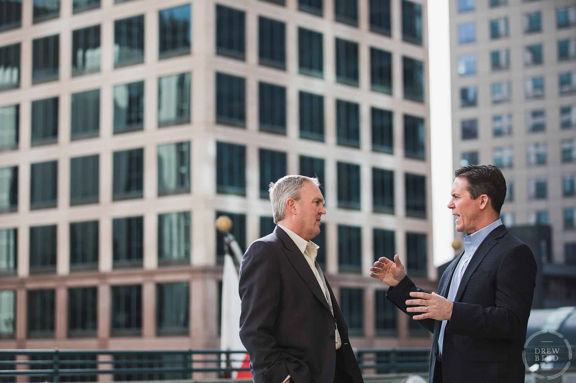 Photo of two corporate businessmen talking outside an office building. Photo by San Francisco corporate photographer Drew Bird Photo.