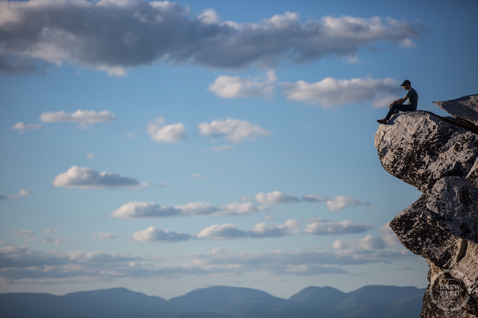 Man sitting on a cliff edge in the Gunks commercial photo for rock climbing lifestyle photo shoot.