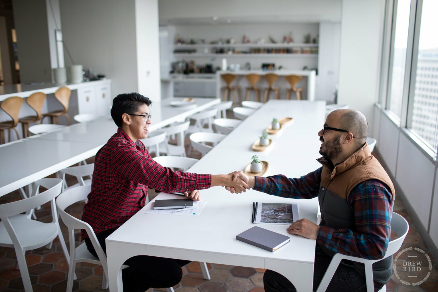 Two men shaking hands in corporate office. San Francisco corporate lifestyle photographer Drew Bird.