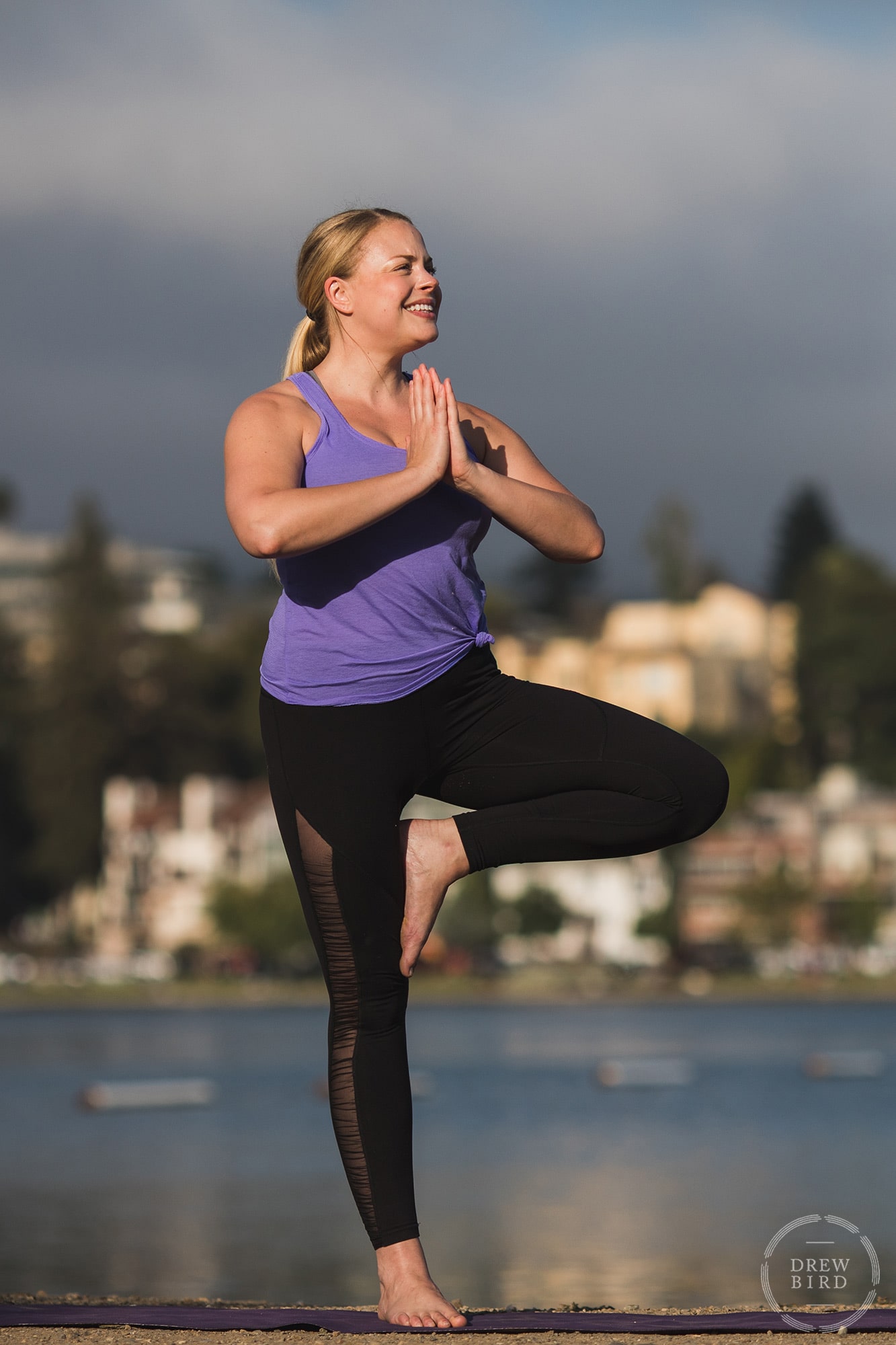 Yoga instructor in tree pose on shores of Lake Merrit in Oakland. San Francisco yoga instructor, brand, and commercial photographer Drew Bird.