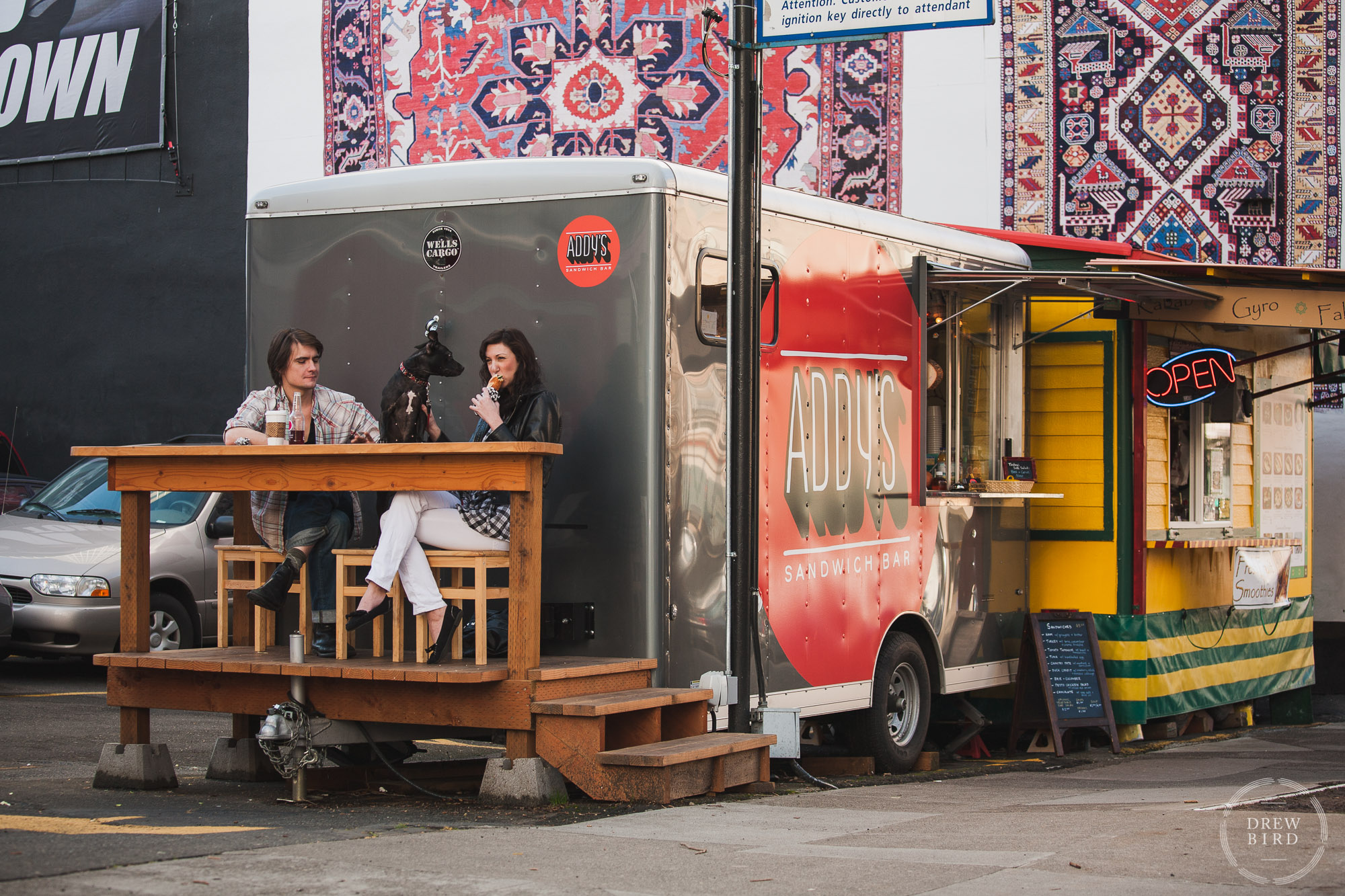 Portland Oregon food carts. Addie's sandwiches with a man and woman eating on a raised deck.