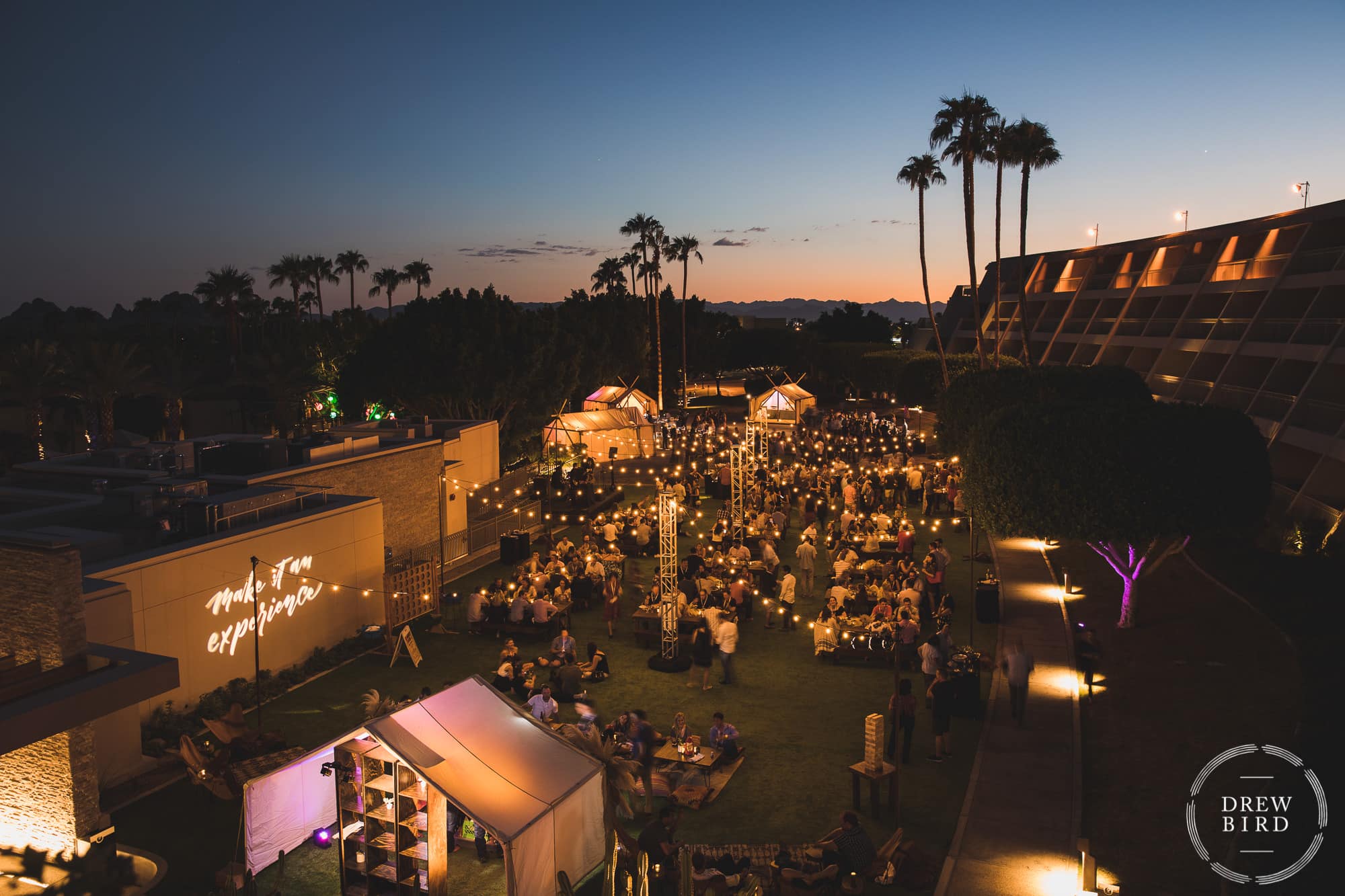 Corporate event at luxury resort Phoenician in Scottsdale, Arizona. Sunset and a big party with palm trees in distance.
